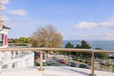 a balcony with a view of a street and the ocean at Muthu Westcliff Hotel (Near London Southend Airport) in Southend-on-Sea