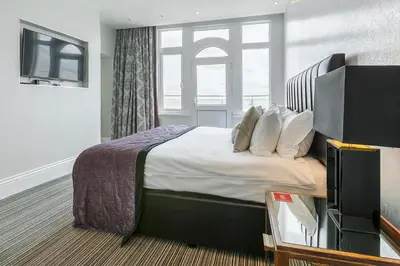 a hotel room with a bed and a television at Muthu Westcliff Hotel (Near London Southend Airport) in Southend-on-Sea
