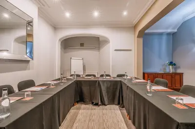 a large long table in a room with chairs at Muthu Westcliff Hotel (Near London Southend Airport) in Southend-on-Sea