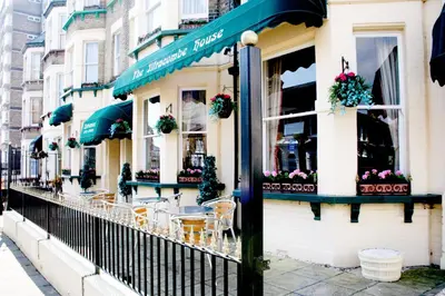 a restaurant with tables and chairs on a street at Ilfracombe House Hotel - near Cliffs Pavilion in Southend-on-Sea