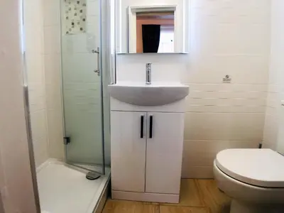 a bathroom with a sink and a toilet and a shower at Ilfracombe House Hotel - near Cliffs Pavilion in Southend-on-Sea