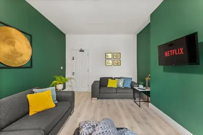 a living room with a couch and a tv at The Suffolk Gem - Games Room in Ipswich