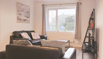 a living room with a couch and a window at Grace's Place in Ely in Ely