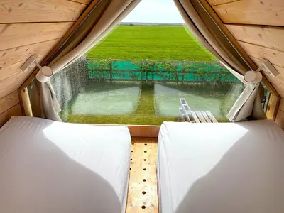 a room with a window with a view of a field at Lushna 4 Petite at Lee Wick Farm Cottages & Glamping in Clacton-on-Sea