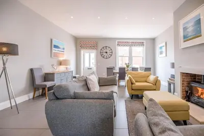 a living room with two couches and a fireplace at Lyndhurst, Aldeburgh in Aldeburgh