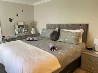 a bedroom with a large bed with stars on the wall at La de da Frinton on Sea in Frinton-on-Sea