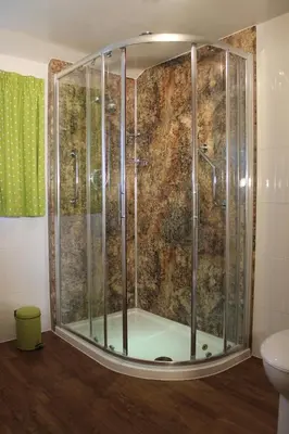 a shower with a glass enclosure in a bathroom at Colston Hall Farmhouse B&B in Framlingham
