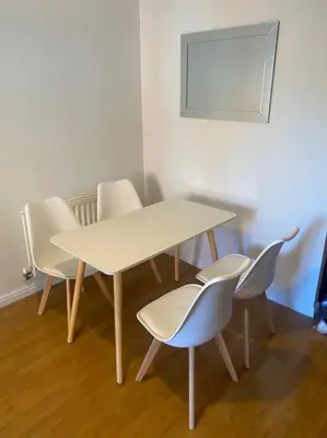 a table and chairs with a white table and a mirror at Colchester Smart Two Bed Apartment in Colchester