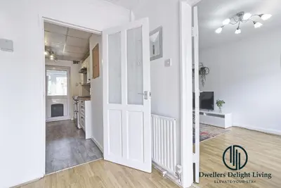 an open kitchen and living room with white walls at Purple Velvet - 2 Bed Home Spacious - Basildon Essex Upto 5 Guests, Free Wifi , Free Parking in Basildon