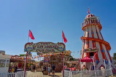 a carnival with a ferris wheel and a ride at Stunning Lodge With Decking At Oaklands Holiday Park In Essex Ref 39017Rw in Clacton-on-Sea
