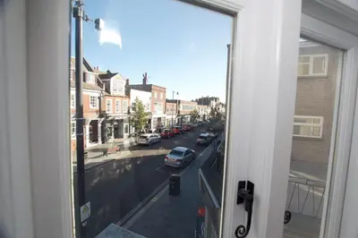 a view from a window of a street with cars at Beautiful large 3-bed coastal flat with parking. in Frinton-on-Sea