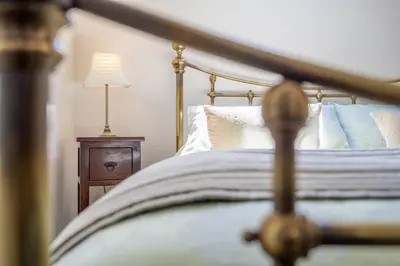 a bedroom with a bed and a table with a lamp at Escape in Aldeburgh