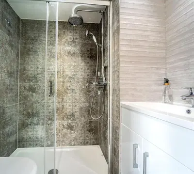 a bathroom with a shower and a tub and a sink at 5 Bed Farmhouse Suitable for Contractors Private Parking in Potter Street
