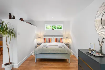 a small bedroom with a bed and a window at Attractive 2 storey, 2 bedroom barn in Long Melford in Long Melford