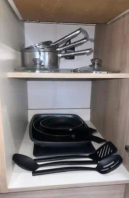 a black plate and utensils on a shelf in a kitchen at Brand New Modern Holiday Home - Haven The Orchards Holiday Park in Saint Osyth