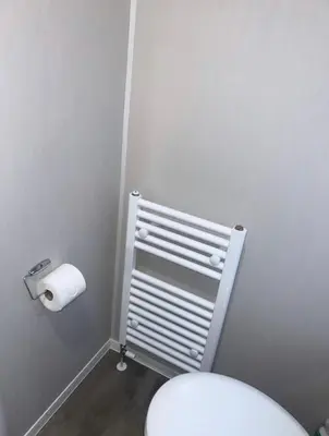a bathroom with a toilet and a roll of toilet paper at Brand New Modern Holiday Home - Haven The Orchards Holiday Park in Saint Osyth