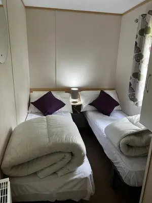 a room with two beds with pillows on them at Lovely place in Saint Osyth