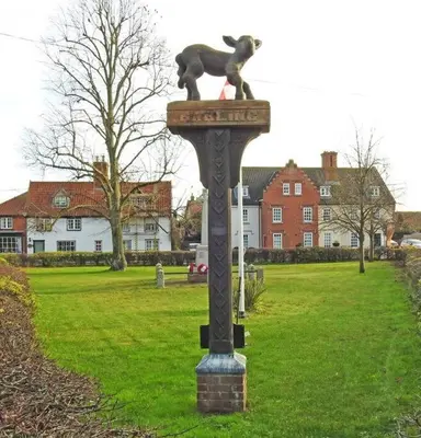 a statue of a cat on a pole in a field at The Lodge - 2 acres of garden with hot tub and fire pit and BBQ in East Harling