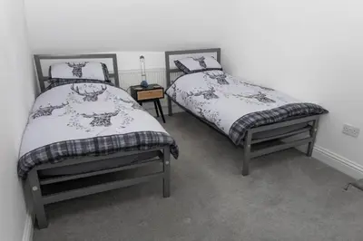 two twin beds in a room with at The Thatched Flat at The Sorrel Horse in Shottisham