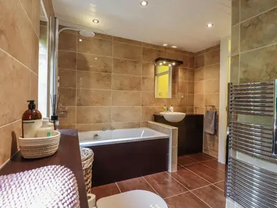 a bathroom with a tub and a sink at 256 London Road in Colchester