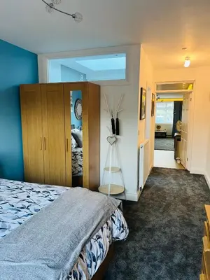 a bedroom with a bed and a room with a window at The Annex in Southend-on-Sea