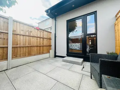 a house with a fence and a patio at The Annex in Southend-on-Sea