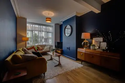 a living room with a couch and a table at Cosy house on the seafront - Pass the Keys in Southend-on-Sea