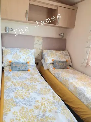 two beds sitting next to each other in a bedroom at The James Lodge in Little Clacton