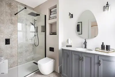 a bathroom with a shower and a toilet and a sink at Beautiful Spacious Beach Home Newly Renovated in Felixstowe