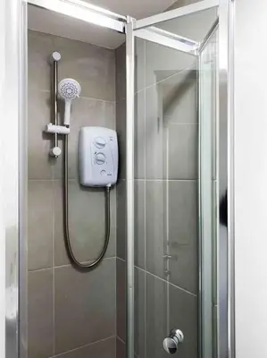 a shower in a bathroom with a glass door at Modern flat near train station with free parking in Cambridge