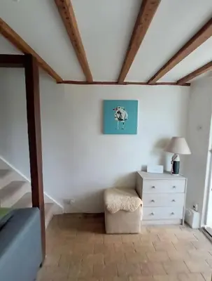 a attic room with a dresser and a lamp at Period Cottage near Suffolk Coast and Forest in Tunstall