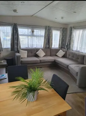 a living room with a couch and a table at Kjs holiday home in Saint Osyth