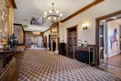 a large room with a hallway with a chandelier at Darcy West in Colchester