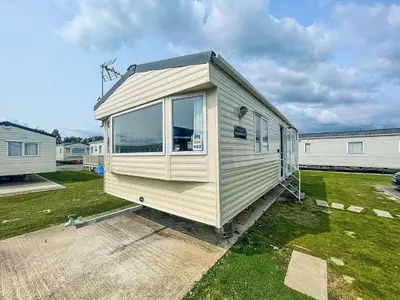 a tiny house is parked in a yard at 2br-sleeps6-wifi-freeparking-holidaypark in Clacton-on-Sea