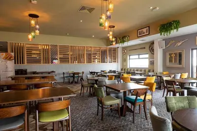 a restaurant with tables and chairs in a room at 2br-sleeps6-wifi-freeparking-holidaypark in Clacton-on-Sea