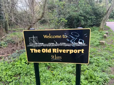 a sign that says welcome to the old riverport sights at Contractor, families and bikes in Earith