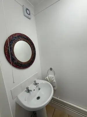 a bathroom with a sink and a mirror on the wall at Contractor, families and bikes in Earith