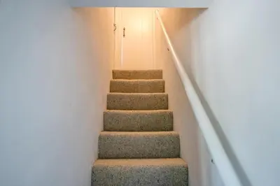 a set of stairs in a house at Wonderful cottage with sun-filled terrace in Aldringham