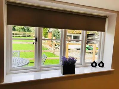 a window with a window shade in a room at The Cottage in Birdbrook