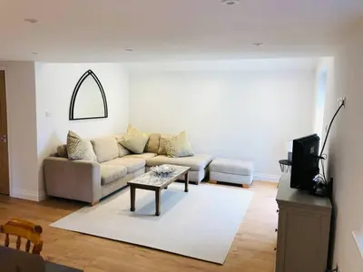 a living room with a couch and a table at The Cottage in Birdbrook