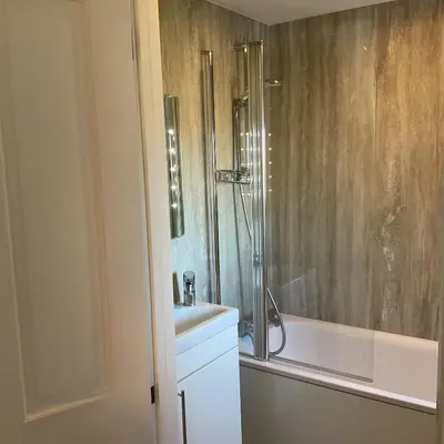 a bathroom with a shower and a sink and a tub at Peaceful house ideal for dogs lovely location in Aldeburgh