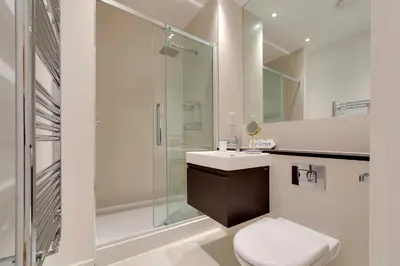 a bathroom with a shower and a toilet and a sink at Pass the Keys Stunning and Spacious Modern Flat - Own Car Park in Cambridge