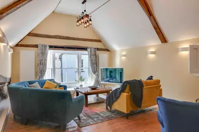 a living room with couches and a table at Josua Medieval Living Maldon in Maldon