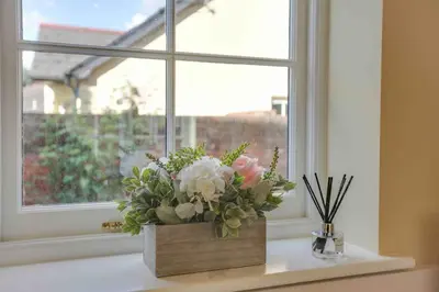 a vase of flowers sitting on a window sill at Josua Medieval Living Maldon in Maldon