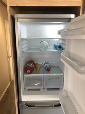 an open refrigerator with its door open with toys in it at Beach house fun in Walton-on-the-Naze