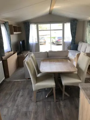 a living room with a table and chairs and a couch at Beach house fun in Walton-on-the-Naze