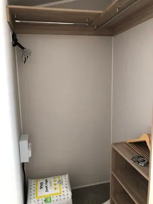 a corner of a room with a bed and a light at Beach house fun in Walton-on-the-Naze