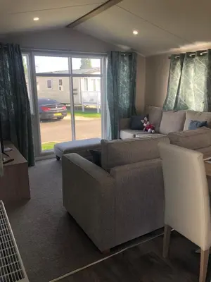a living room with a couch and a window at Beach house fun in Walton-on-the-Naze