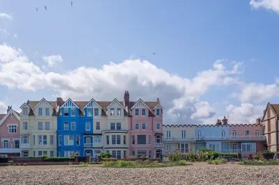 a row of colorful houses on the beach at Granary Cottage in Wenhaston