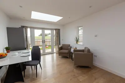 a kitchen and dining room with a table and chairs at The Poppies Cottage in Six Mile Bottom
